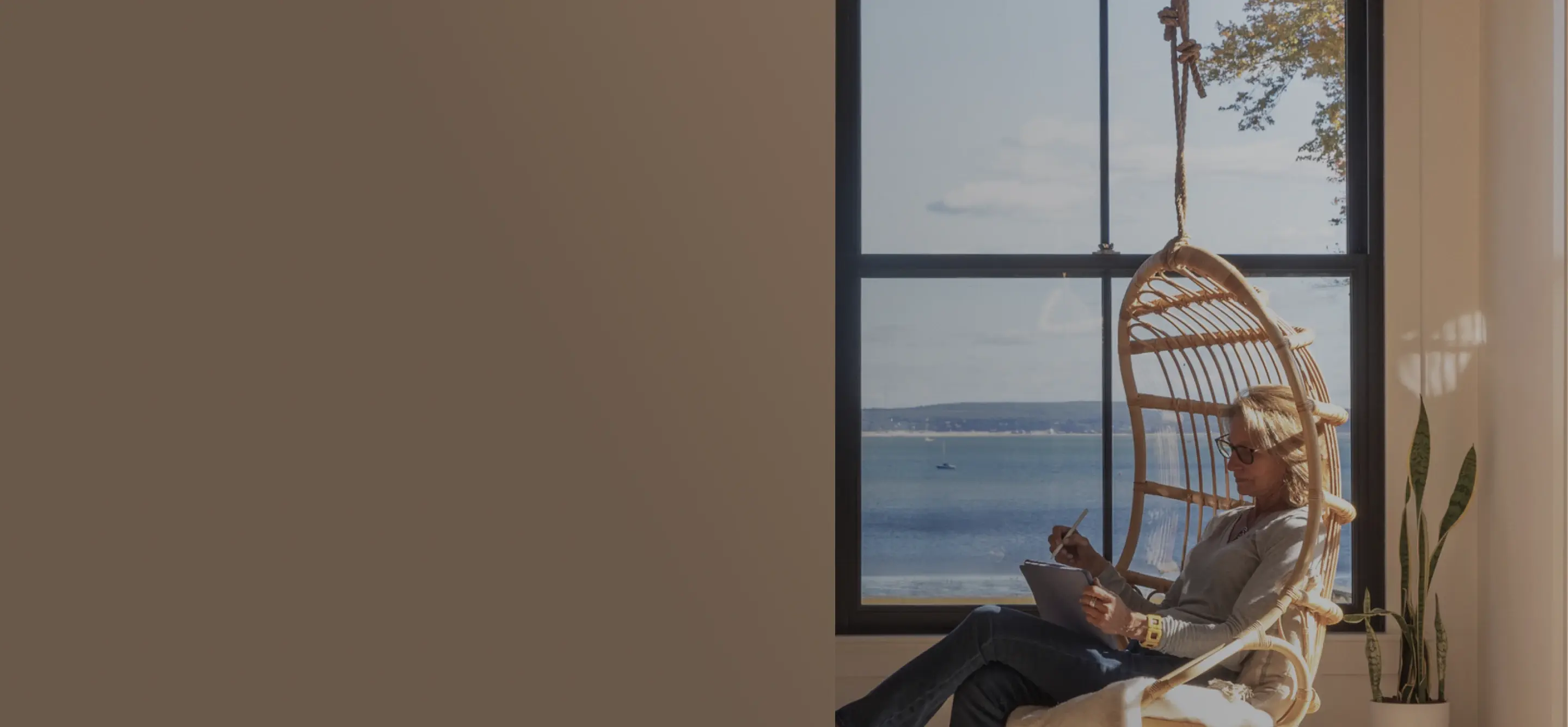 Cozy seating area beside a window with a view of the ocean.