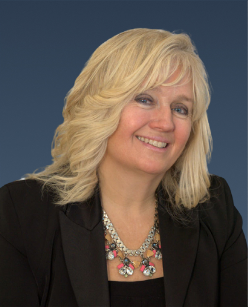 Professional portrait of a woman with blonde hair in a dark suit, smiling slightly.