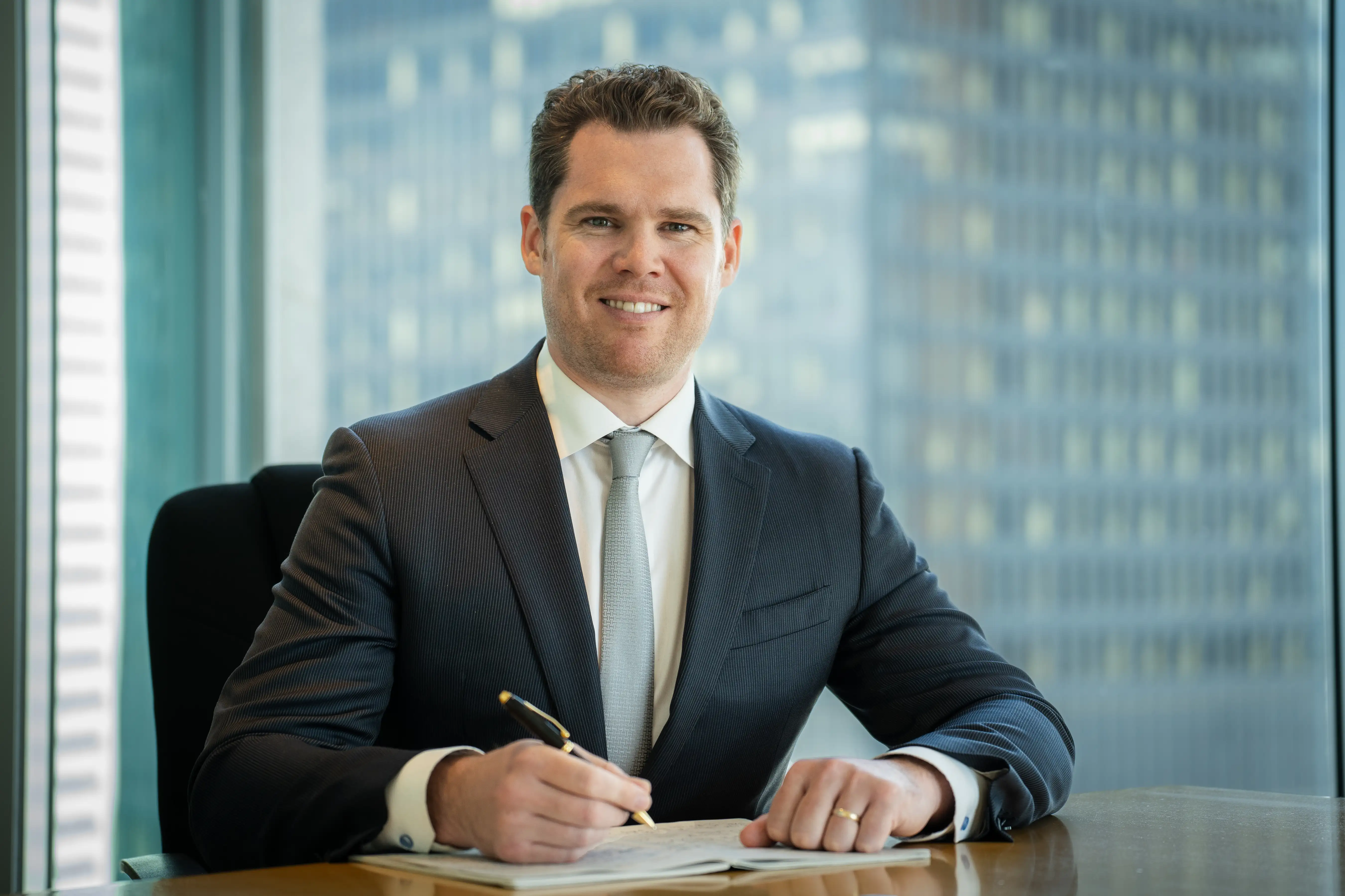 Portrait of Conner Cameron – professional headshot with neutral background and friendly expression.